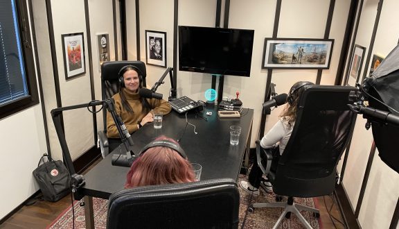 Kuva äänitysstudiosta jossa yksi nuori näkyy kasvoillaan ja kaksi muutaovat selin